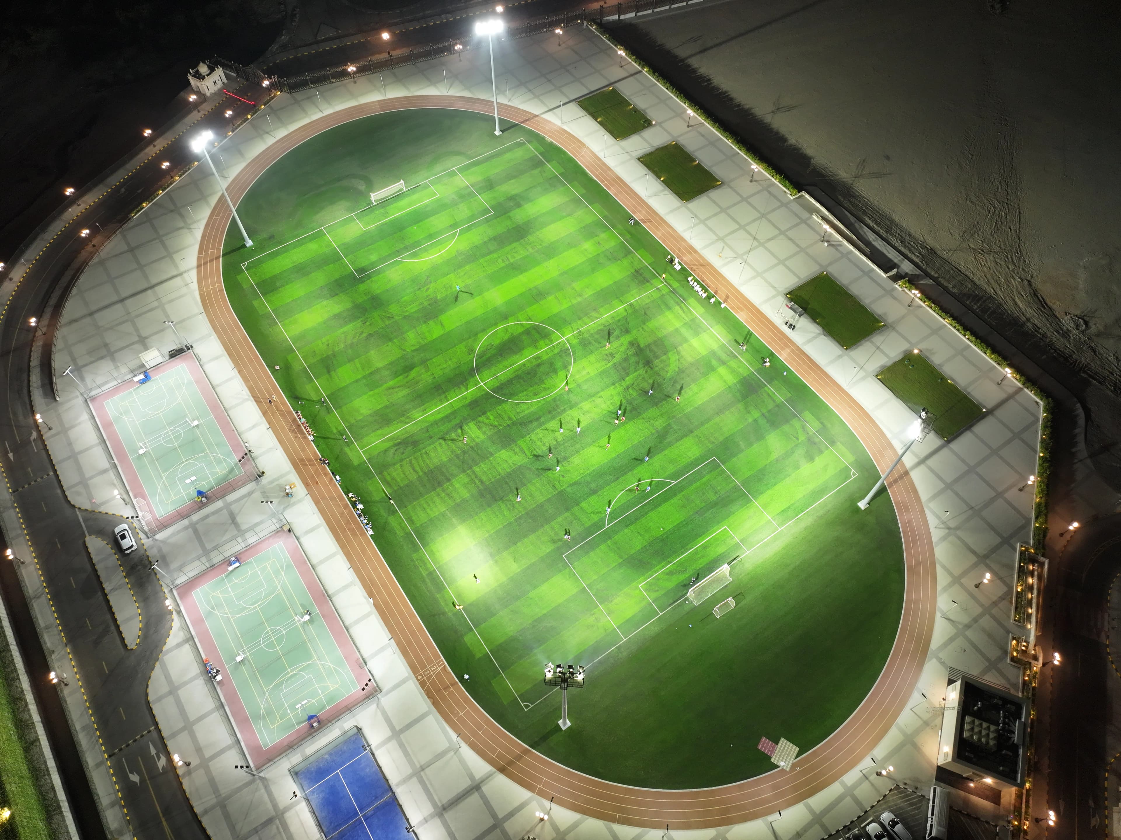 Evening football match under floodlights